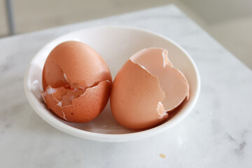 eggshells in a white color bowl on table 