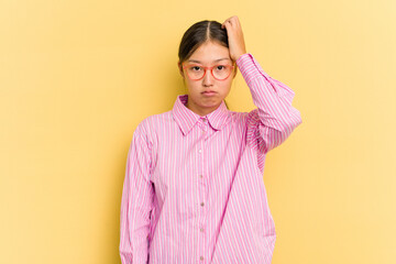Fototapeta premium Young Asian woman isolated on yellow background tired and very sleepy keeping hand on head.