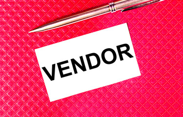 White business card with the text VENDOR and a golden pen on a burgundy background. A rectangle of...