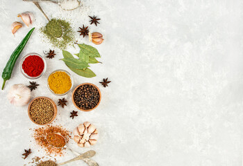 Fototapeta na wymiar A variety of spices and herbs on a light table. Preparing the background. View from above. Ingredients for cooking. Table background menu.