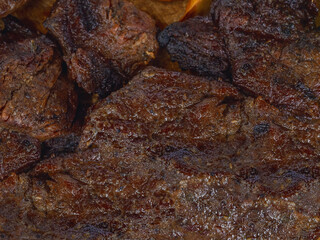Detail of a well cooked grilled steak with marked lines and juicy