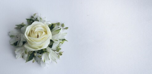 A festive bouquet with a white rose on a white background. Pastel shades. Background for for a greeting card.