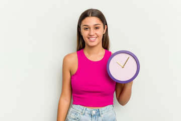 Young Indian woman holding a clock isolated on white background happy, smiling and cheerful.