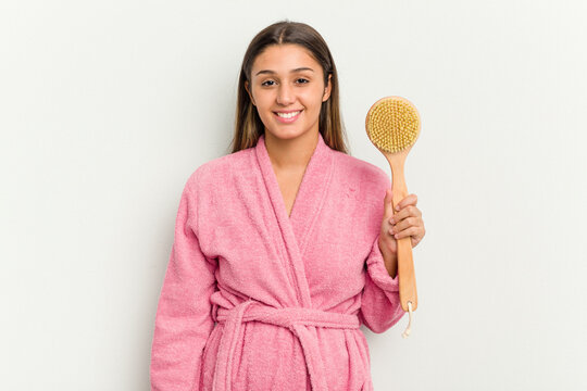 Young Indian Woman Holding A Shower Brush Isolated On White Background Happy, Smiling And Cheerful.