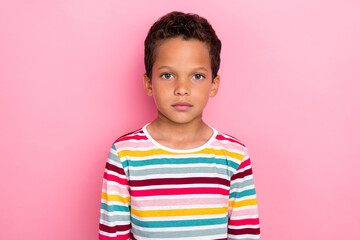 Photo portrait of cute little hispanic boy looking calm camera shopping promo wear stylish striped look isolated on pink color background