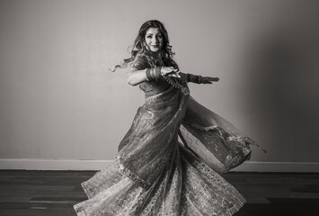 Fototapeta na wymiar Black and white portrait of Indian dancer moving 