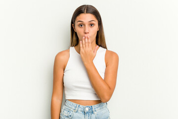 Young Indian woman isolated on white background shocked, covering mouth with hands, anxious to discover something new.