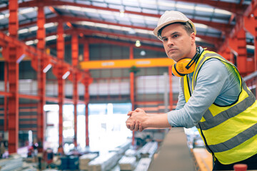 Portrait smart professional caucasian Industrial, factory engineer,technician,worker man stand confidence with safety helmet in steel metal sheet production, manufacture worker concept with copy space