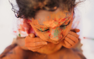 Holi color on a little girl's face 