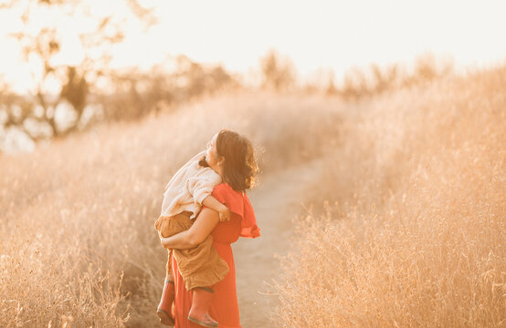 A motherhood portrait with her daughter outdoors