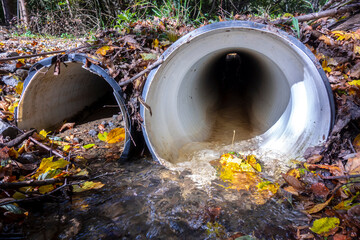 A drainage pipe in nature for the flow of a small stream under a forest road