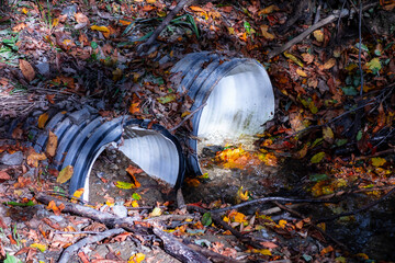 A drainage pipe in nature for the flow of a small stream under a forest road