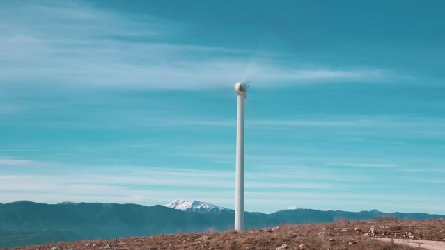 A wind farm or wind park located on the mountains with snow in Italy Europe. It allows to realize clean energy. It&rsquo;s sustainable, renewable energy for enviromental