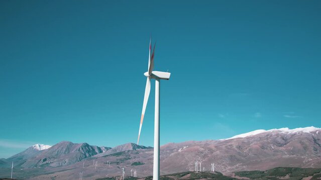 A wind farm or wind park located on the mountains with snow in Italy Europe. It allows to realize clean energy. It&rsquo;s sustainable, renewable energy for enviromental