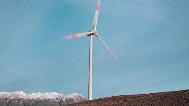 A wind farm or wind park located on the mountains with snow in Italy Europe. It allows to realize clean energy. It&rsquo;s sustainable, renewable energy for enviromental