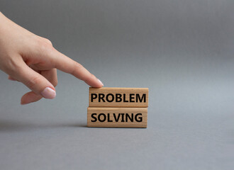 Problem solving symbol. Concept word Problem solving on wooden blocks. Beautiful grey background. Businessman hand. Business and concept. Copy space