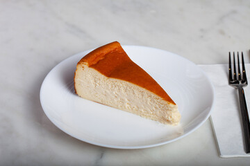San Sebastian Cheesecake Slice on a White Plate