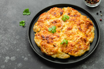 Baked cheddar ranch chicken, cheesy, vegetables in cast iron skillet. Top view, copy space, flat lay.