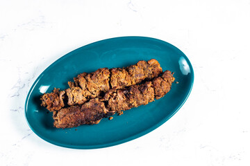 spicy bbq chicken seekh kabab served in a dish isolated on background top view