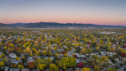 October dawn over Fort Collins and foothills of Rocky Mountains in northern Colorado, aerial...