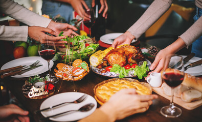 Close up Christmas or Thanksgiving dinner table infront of fireplace and xmas tree decorated at home. Holiday and festival spending time together with family or friends .