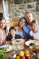 Its always better when were together. A portrait of a happy multi-generational family having lunch together at home.