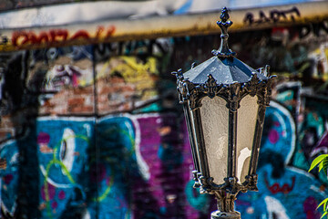 Vintage lantern on the background of modern graffiti	
