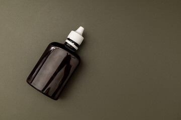 Jars and bottles of cosmetics on a dark background, the minimalism of the beauty industry