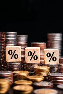 Stack of coins with Wood blocks with percentage symbol. increasing price concept. increase or decrease interest. vertical.   