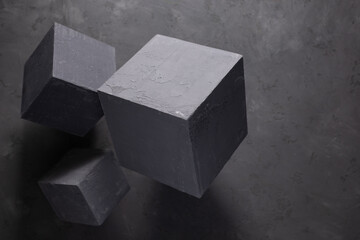 Concrete cube shape on floor background texture. Cement block as construction concept