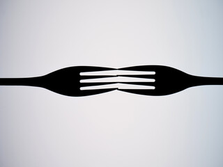 Outlines of two forks against a white background. copy space
