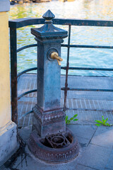 old drinking fountain on the waterfront of the city