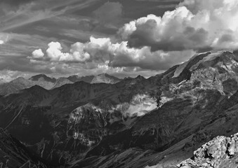 Fototapeta na wymiar view of the alps, mountains high in the clouds. black and white landscape