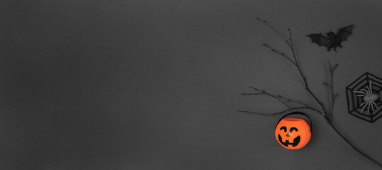 Halloween black background with bats, spiders, pumpkins and twigs. Modern Holiday design. Halloween party border on Dark Gray colour. Flat lay, top view, copy space. Thanksgiving fall decoration. 2022
