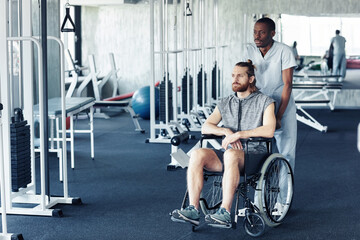African doctor pushing patient with disability in wheelchair for sport exercises in health club
