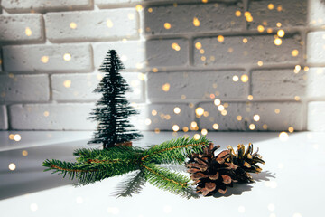 New Year, Christmas background. New Year's decor on a white table, decorative fir, pine cones and green branches. Front view