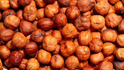 Heap of hazelnuts close-up. Peeled nuts. Hazelnut isolated on white background.