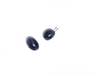 Two fresh plums on white background