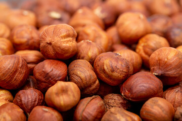 Heap of hazelnuts close-up. Peeled nuts. Hazelnut isolated on white background.
