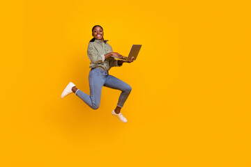 Fototapeta na wymiar Full body photo of excited active person hold wireless netbook rush isolated on yellow color background