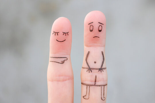 Fingers art of the wife laughs at her husband. Concept of impotence. Divorce.