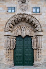 Fototapeta na wymiar Beautiful facade with reliefs and entrance door to the Colegio de San Jerónimo, Santiago de Compostela, Galicia, Spain. Santiago's road.