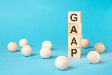 word GAAP with wood building blocks, light blue background