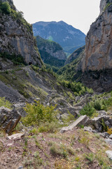magnificent view of a long glacial forested valley through cloud topped Spanish Pyrenees mountains