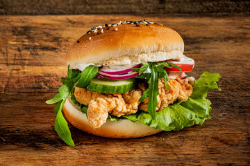 tasty burger on the wooden background