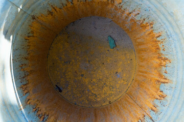 centre of bucket covered with orange thick rust