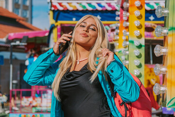 Obraz na płótnie Canvas girl talking on the mobile phone in the amusement park