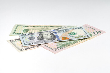 5, 20, 50, 100 dollars banknotes at different angles. Close up of dollars on white background.