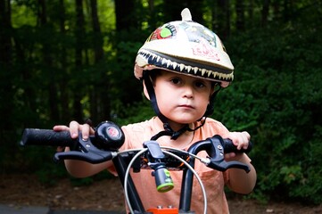 Fototapeta na wymiar Boy on his bike, wearing a bike helemt