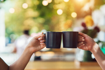 Closeup image of a people clinking coffee cups together in cafe - 539023568